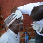 Doctor checks a man's eye with a light