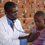 doctor checks a little girl's heart